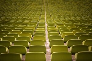 A captivating view of neatly arranged empty green seats in an auditorium.