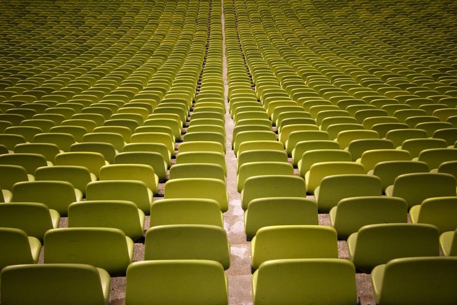 A captivating view of neatly arranged empty green seats in an auditorium.
