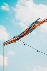 Vibrant streamers fluttering against a bright blue sky on a sunny day.